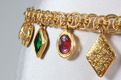 Lot 36 - A Chanel gem-inset belt, signed, with pendants...