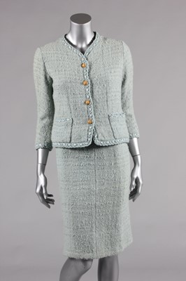 Lot 114 - A Chanel couture pale blue tweed suit, circa...