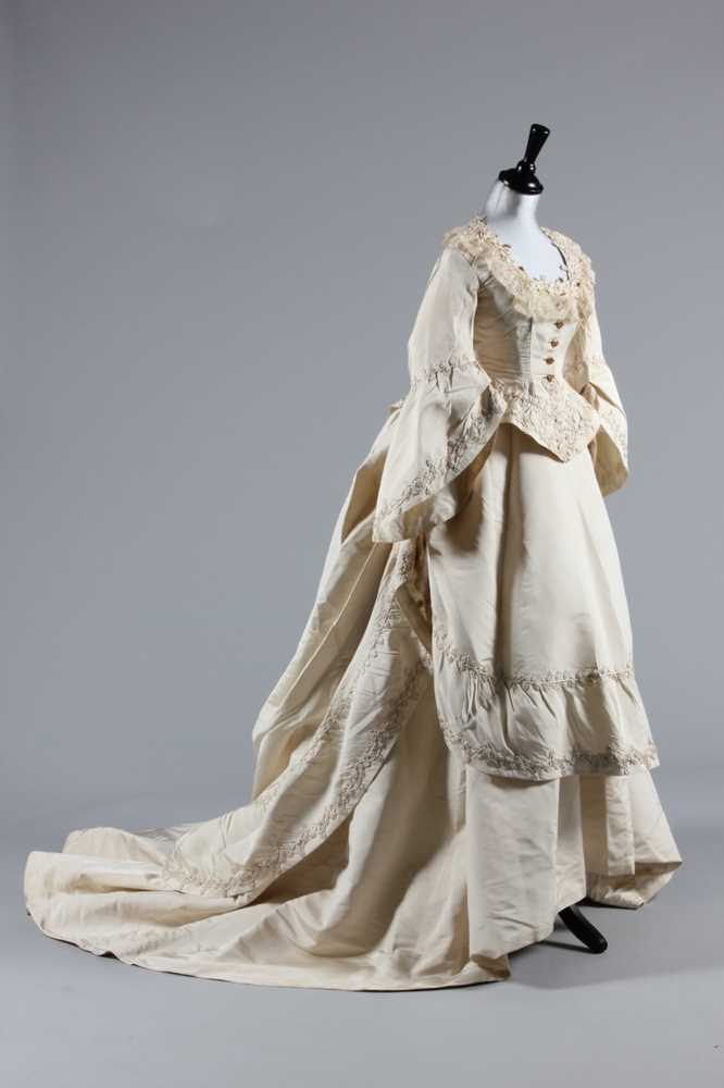 Lot 34 - An ivory silk faille bridal gown, circa 1871,...