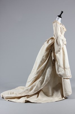 Lot 34 - An ivory silk faille bridal gown, circa 1871,...