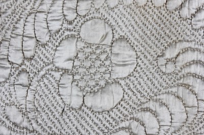 Lot 30 - A quilted ivory satin petticoat, second half...