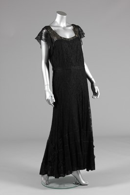 Lot 57 - A Chanel couture black lace evening gown, mid...