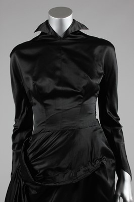 Lot 64 - A Jacques Fath couture black satin dinner gown,...