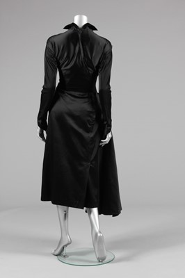 Lot 64 - A Jacques Fath couture black satin dinner gown,...