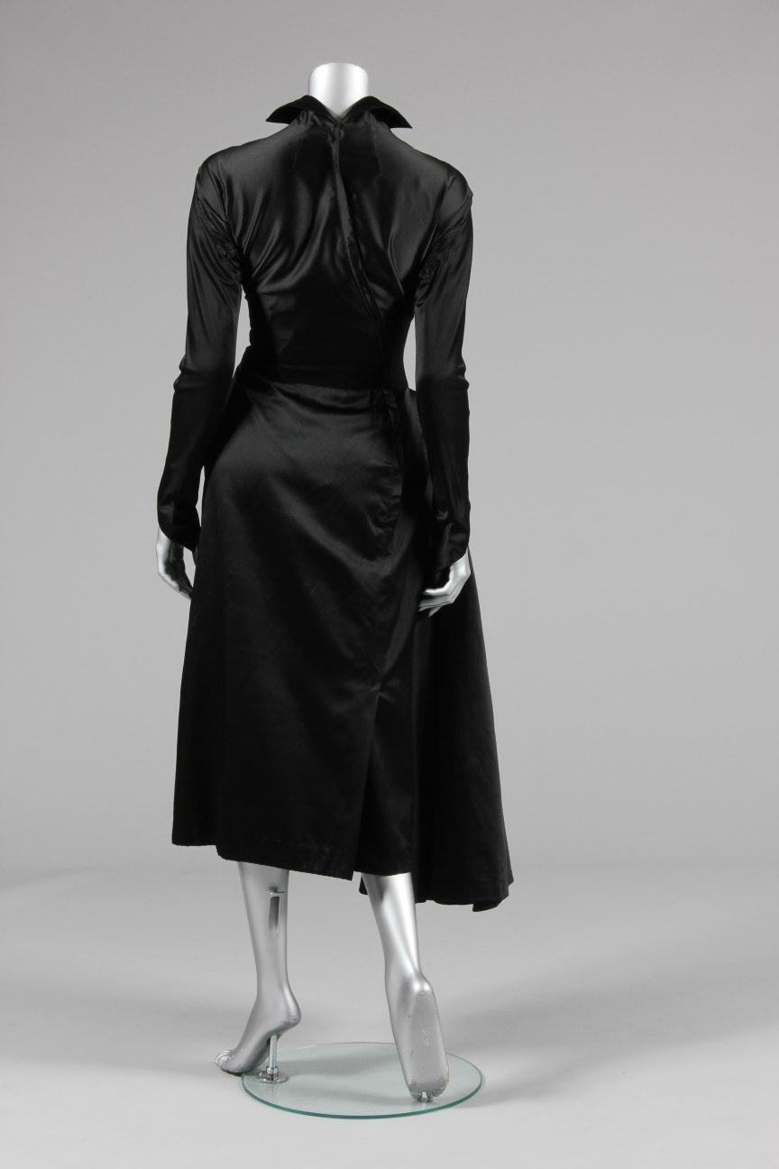 Lot 64 - A Jacques Fath couture black satin dinner