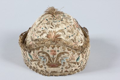 Lot 18 - An embroidered satin undress cap, probably...
