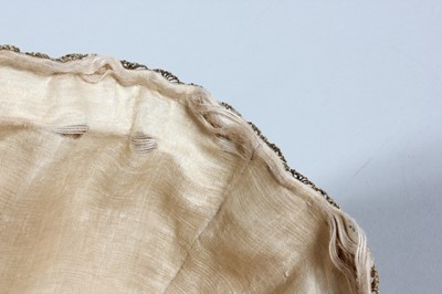 Lot 18 - An embroidered satin undress cap, probably...