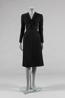 Lot 94 - A Jacques Fath black wool dinner dress, Autumn-...