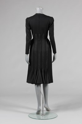 Lot 94 - A Jacques Fath black wool dinner dress, Autumn-...