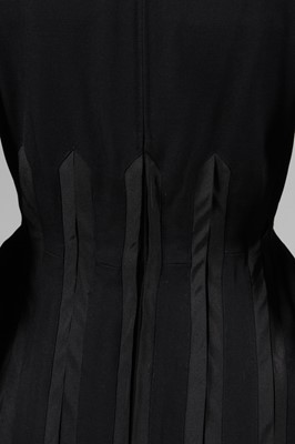 Lot 94 - A Jacques Fath black wool dinner dress, Autumn-...