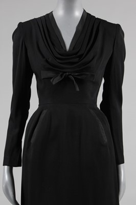 Lot 94 - A Jacques Fath black wool dinner dress, Autumn-...