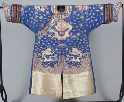 Lot 234 - An embroidered blue silk dragon robe, jifu,...