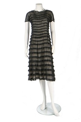 Lot 112 - A finely-pleated black chiffon dress, probably...