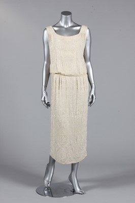 Lot 200 - A beaded ivory silk crepe evening gown, circa...