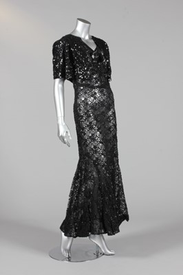 Lot 147 - A black sequined lace evening gown and bolero,...