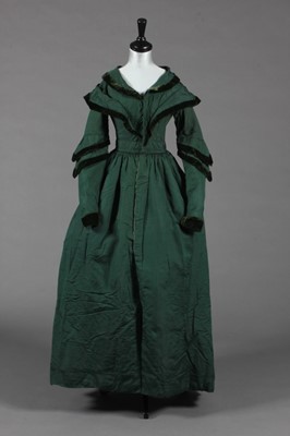 Lot 375 - A bottle green silk pelisse robe, late...