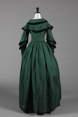 Lot 375 - A bottle green silk pelisse robe, late...