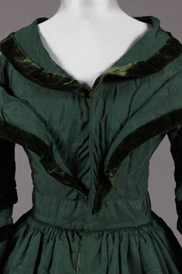 Lot 375 - A bottle green silk pelisse robe, late...