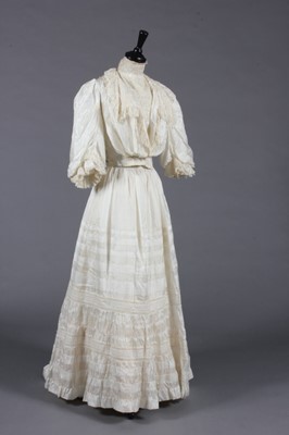 Lot 406 - The bias-cut ivory satin bridal gown and brown...