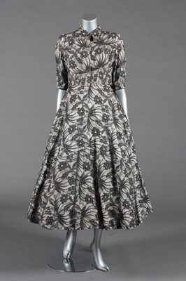 Lot 421 - A Jacques Fath lace dinner gown with matching...