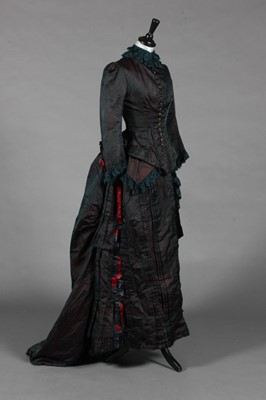 Lot 455 - A blue/wine shot silk evening gown, late 1880s,...