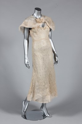 Lot 96 - An oyster cutwork garden party gown, mid 1930s,...