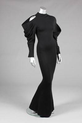 Lot 233 - A Claude Montana black jersey evening gown,...