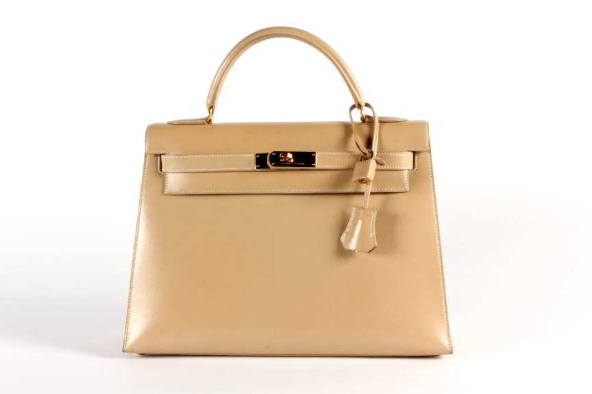 Lot 17 - An Hermès light tan box calf leather Kelly bag,...