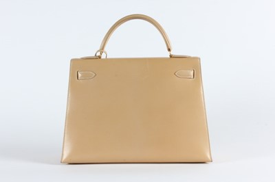 Lot 17 - An Hermès light tan box calf leather Kelly bag,...