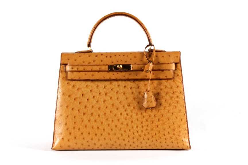 Click for high resolution Lot 12 - An Hermès golden-brown ostrich Kelly bag, 1994,...
