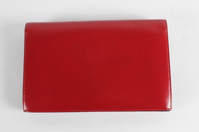 Lot 8 - An Hermès wine leather envelope shaped clutch...
