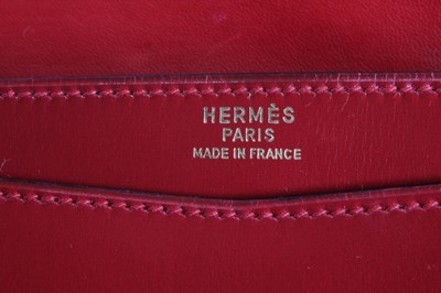 Lot 8 - An Hermès wine leather envelope shaped clutch...