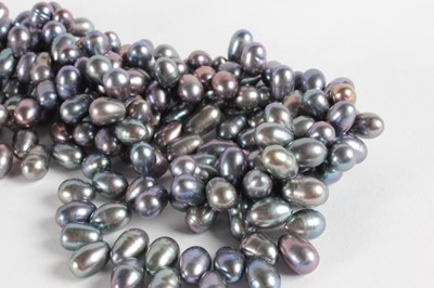 Lot 40 - A triple strand grey pearl necklace, 1980s,...