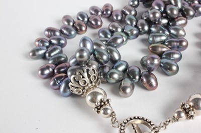 Lot 40 - A triple strand grey pearl necklace, 1980s,...