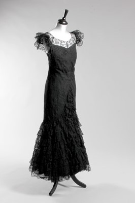 Lot 90 - A Gabrielle Chanel black lace evening gown,...
