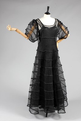 Lot 83 - A black lace and rouleaux satin evening gown,...