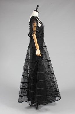 Lot 83 - A black lace and rouleaux satin evening gown,...