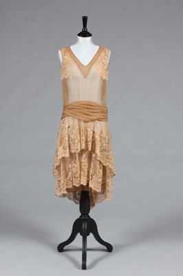 Lot 86 - A couture Brussels lace and beige chiffon gown,...