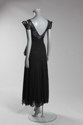 Lot 89 - A Chanel couture black lace evening gown,...