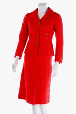 Lot 140 - A Chanel couture bright red tweed suit, 1974,...