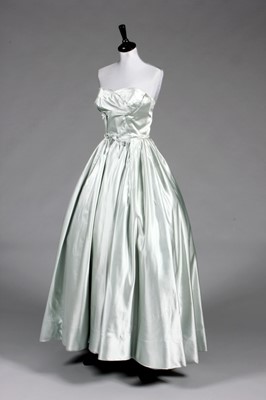 Lot 102 - A Jacques Fath couture ice-blue satin ball...