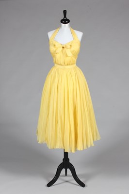 Lot 117 - A Jacques Fath couture yellow organza evening...