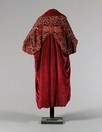 Lot 417 - A fine deep magenta velvet batwing evening...