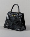 Lot 257 - An Hermès black crocodile skin Kelly bag,...