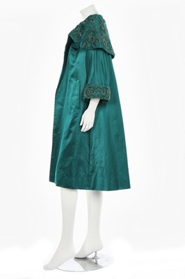 Lot 40 - A peacock-green satin evening coat, probably...