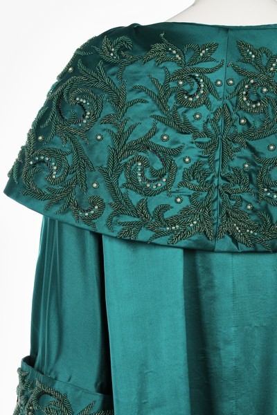 Lot 40 - A peacock-green satin evening coat, probably