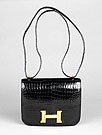 Lot 128 - An Hermès crocodile bag, 1990s, with large...