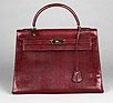 Lot 132 - A burgundy lizard-effect leather Kelly bag,...