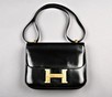 Lot 14 - An Hermès black leather Constance bag, 1960s,...