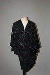 Lot 320 - An Ian & Marcel black rubberised silk batwing...